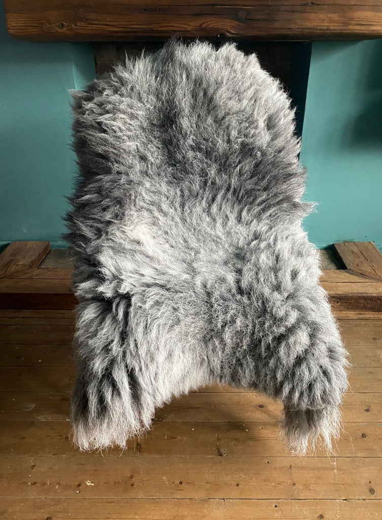 Grey sheepskin rug on chair