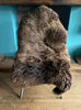 Brown sheepskin rug on chair 