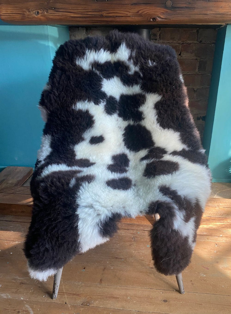 Brown and cream sheepskin rug on chair