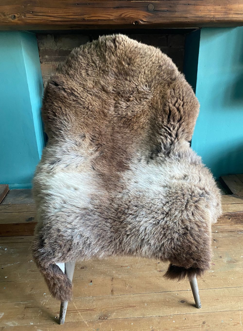 Brown and cream sheepskin rug on chair