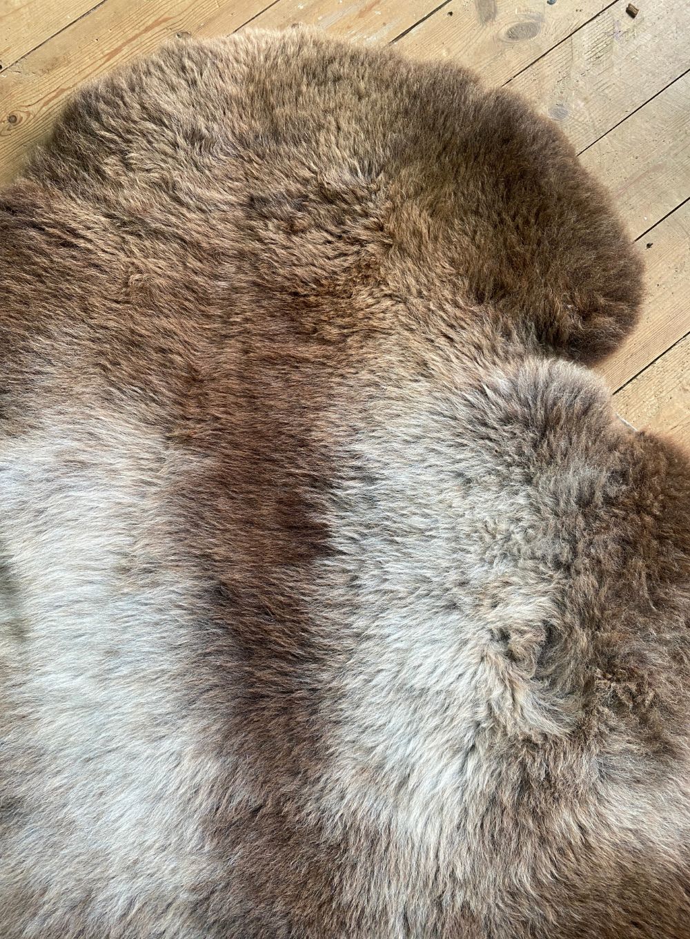 Brown and cream sheepskin rug close up 