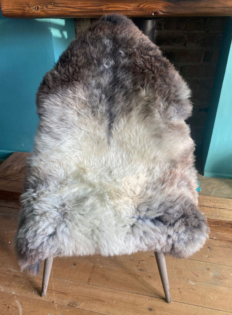 Brown and grey sheepskin rug on chair