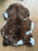 Brown and cream sheepskin rug laid flat 