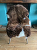 Brown and cream sheepskin rug on chair