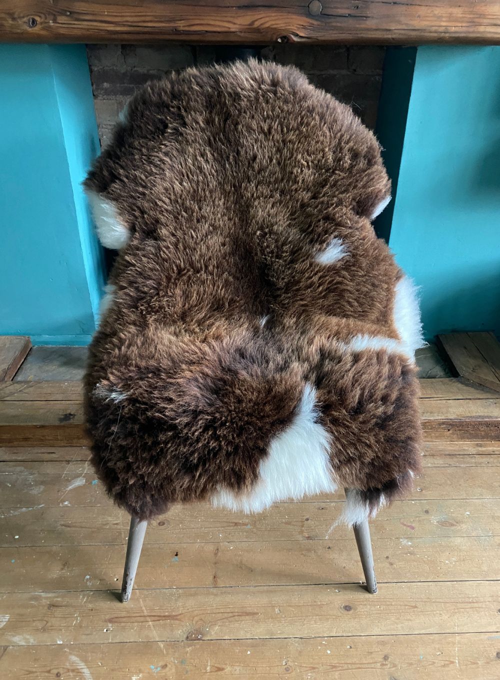 Brown and cream sheepskin rug on chair