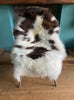 Brown and cream sheepskin rug on chair