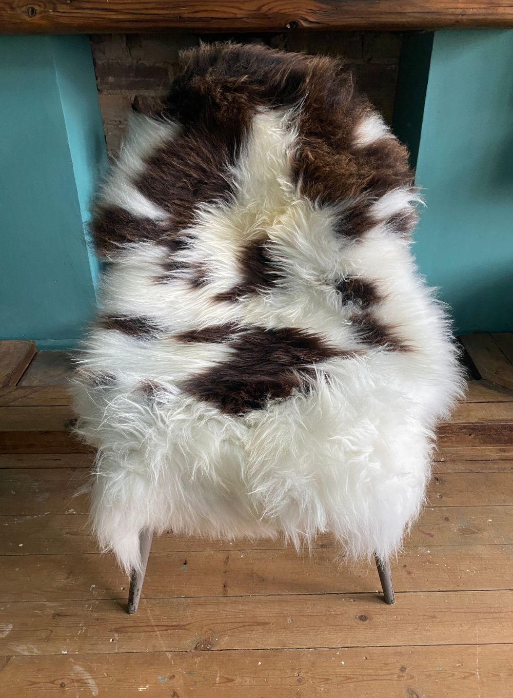 Brown and cream sheepskin rug on chair