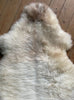 Cream speckled sheepskin rug close up