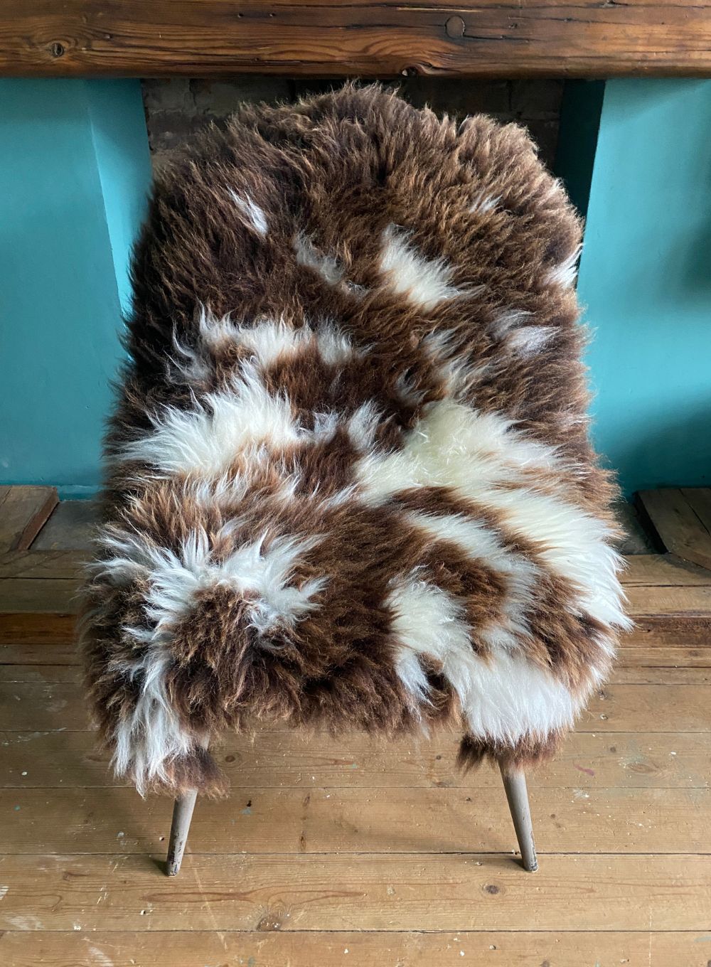 Brown and cream sheepskin rug on chair