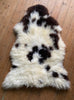 Brown and cream spotty sheepskin  on wooden floor 