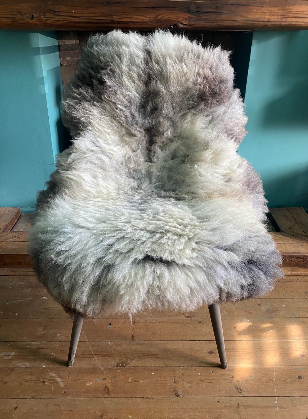 Grey and cream sheepskin rug on chair