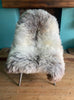 Cream speckled sheepskin rug on chair