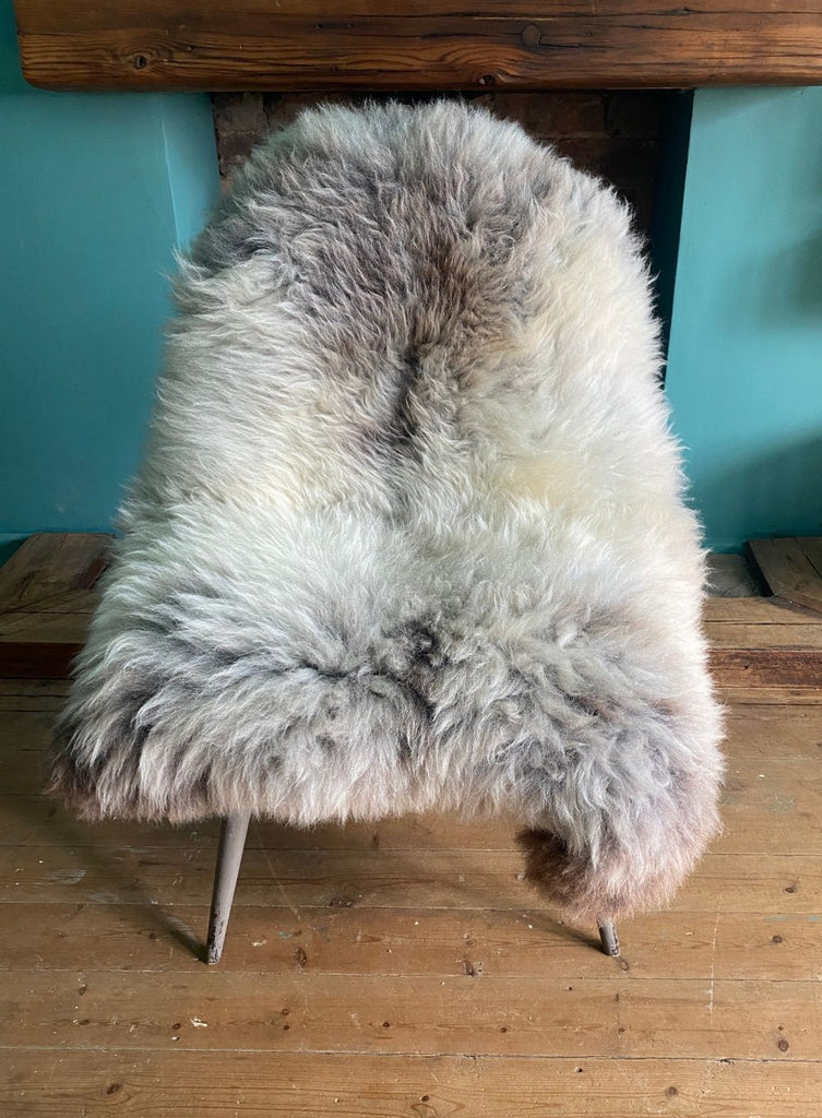 Cream speckled sheepskin rug on chair