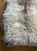 Cream speckled sheepskin rug close up 