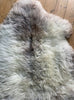 Cream speckled sheepskin rug close up 