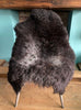 Dark brown sheepskin rug on chair