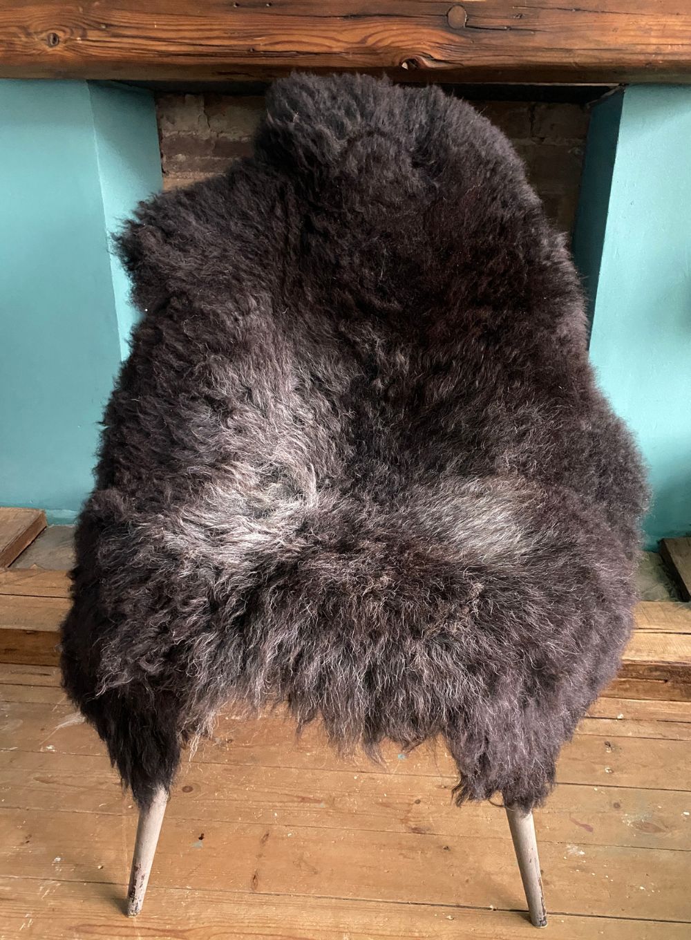 Dark brown sheepskin rug on chair