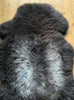 Dark brown sheepskin rug close up