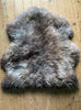 Brown sheepskin rug on wooden floor