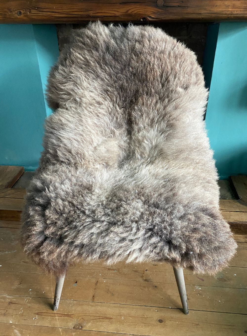 Brown and grey sheepskin rug on chair