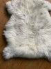 Cream speckled sheepskin rug close up