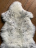 Cream speckled sheepskin rug close up