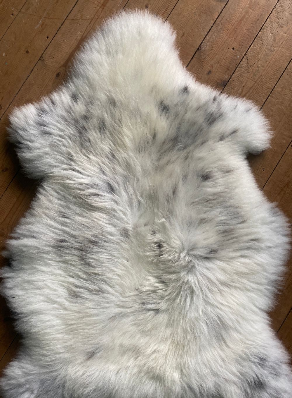 Cream speckled sheepskin rug close up