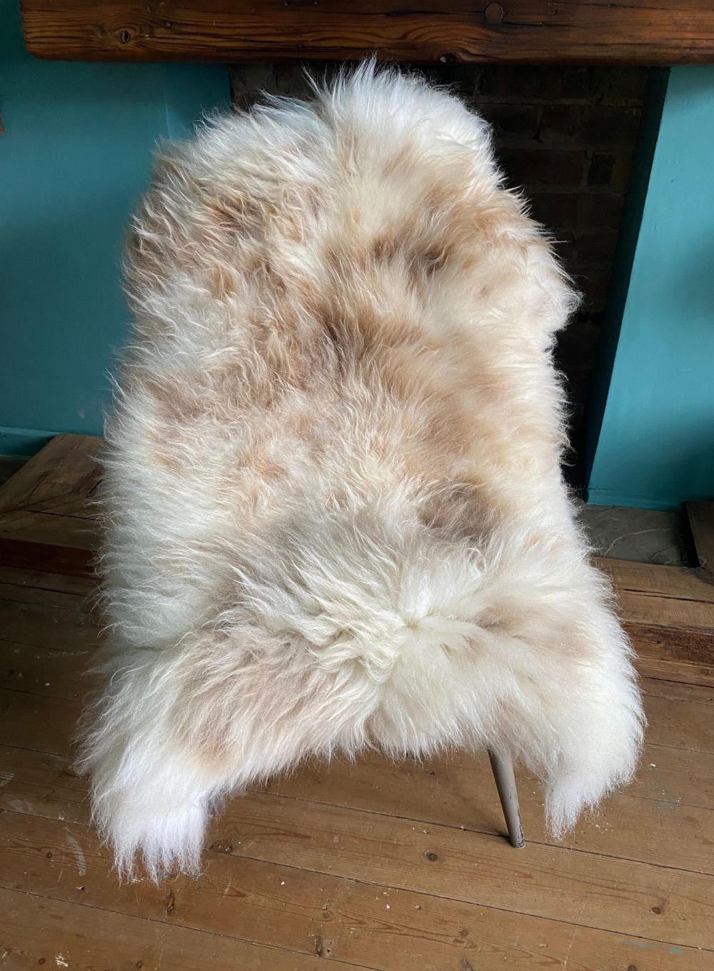 Cream speckled sheepskin rug on chair