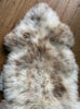 Cream speckled sheepskin rug close up
