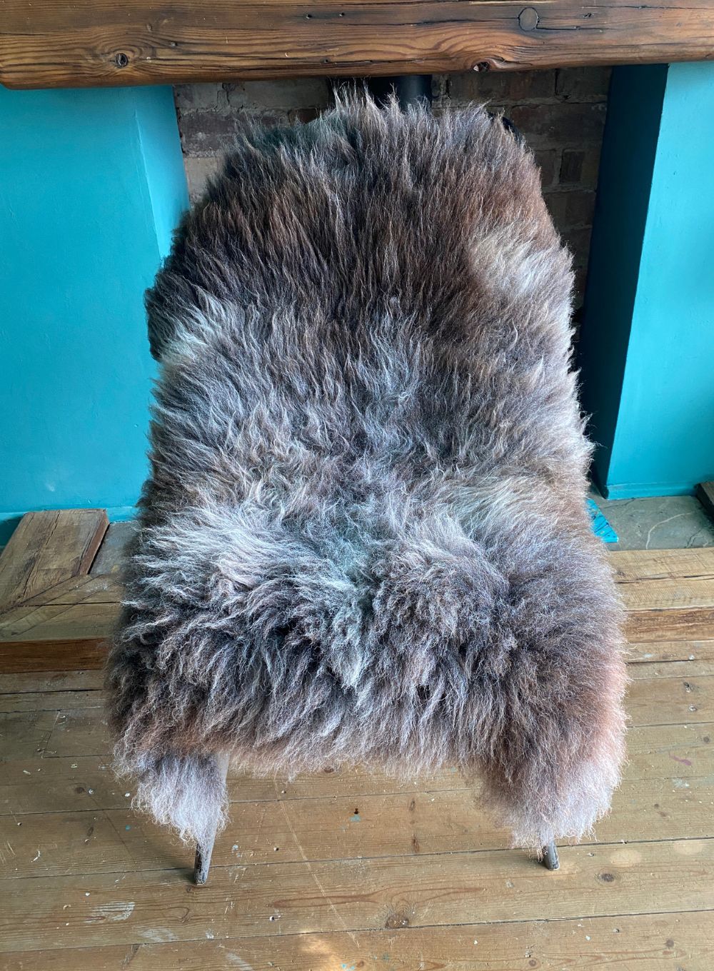 Brown and grey sheepskin rug on chair 