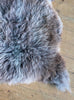 Brown and grey sheepskin rug close up