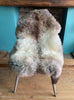 Grey and brown sheepskin rug on chair