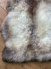Grey and brown sheepskin rug close up