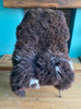 Brown sheepskin rug on chair 