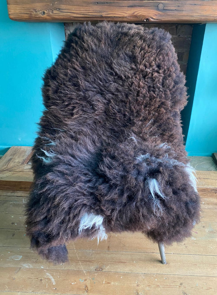 Brown sheepskin rug on chair 