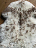 Cream speckled sheepskin rug close up
