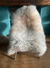 Cream speckled sheepskin rug on chair