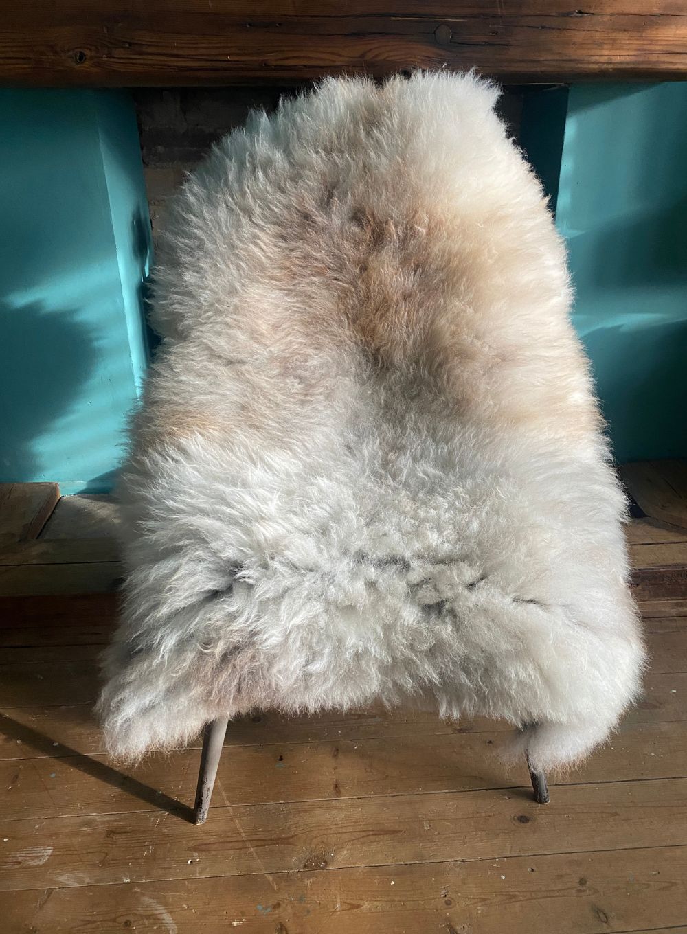 Cream speckled sheepskin rug on chair
