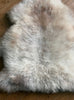 Cream speckled sheepskin rug close up
