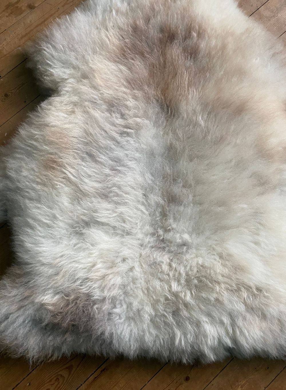 Cream speckled sheepskin rug close up
