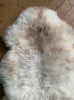 Cream speckled sheepskin rug close up