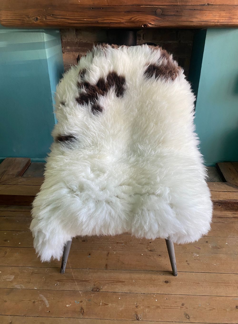 Cream and brown sheepskin rug on chair
