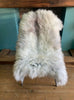 Cream sheepskin rug on chair