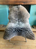 Brown and grey sheepskin rug on chair