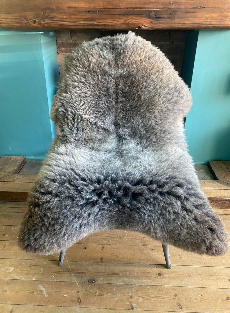 Brown and grey sheepskin rug on chair