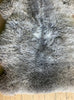 Brown and grey sheepskin rug close up 