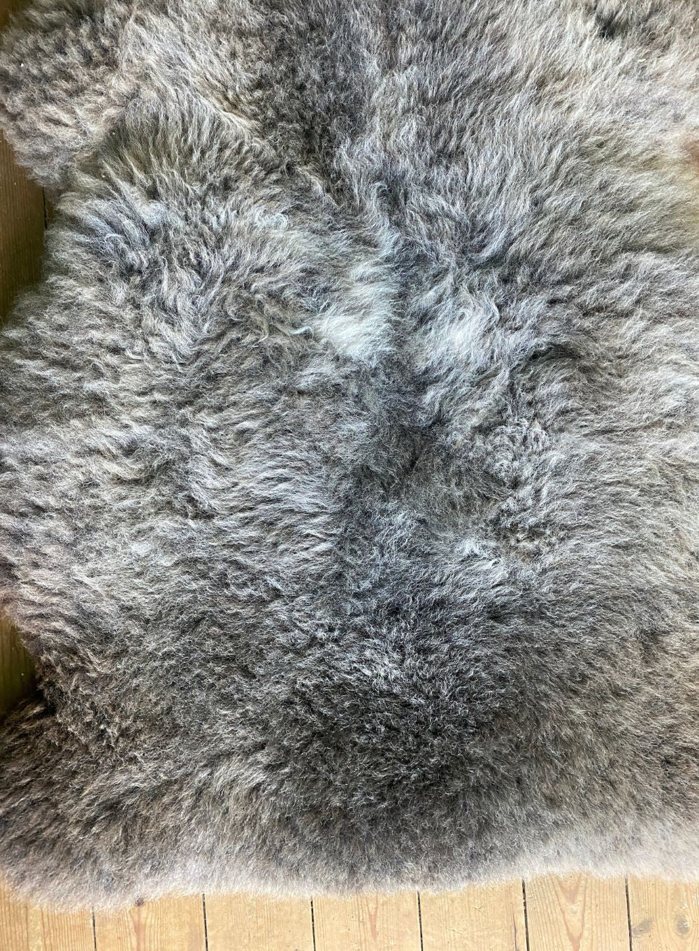 Brown and grey sheepskin rug close up 