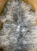 Brown and grey sheepskin rug close up 