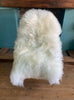Cream sheepskin rug on chair 