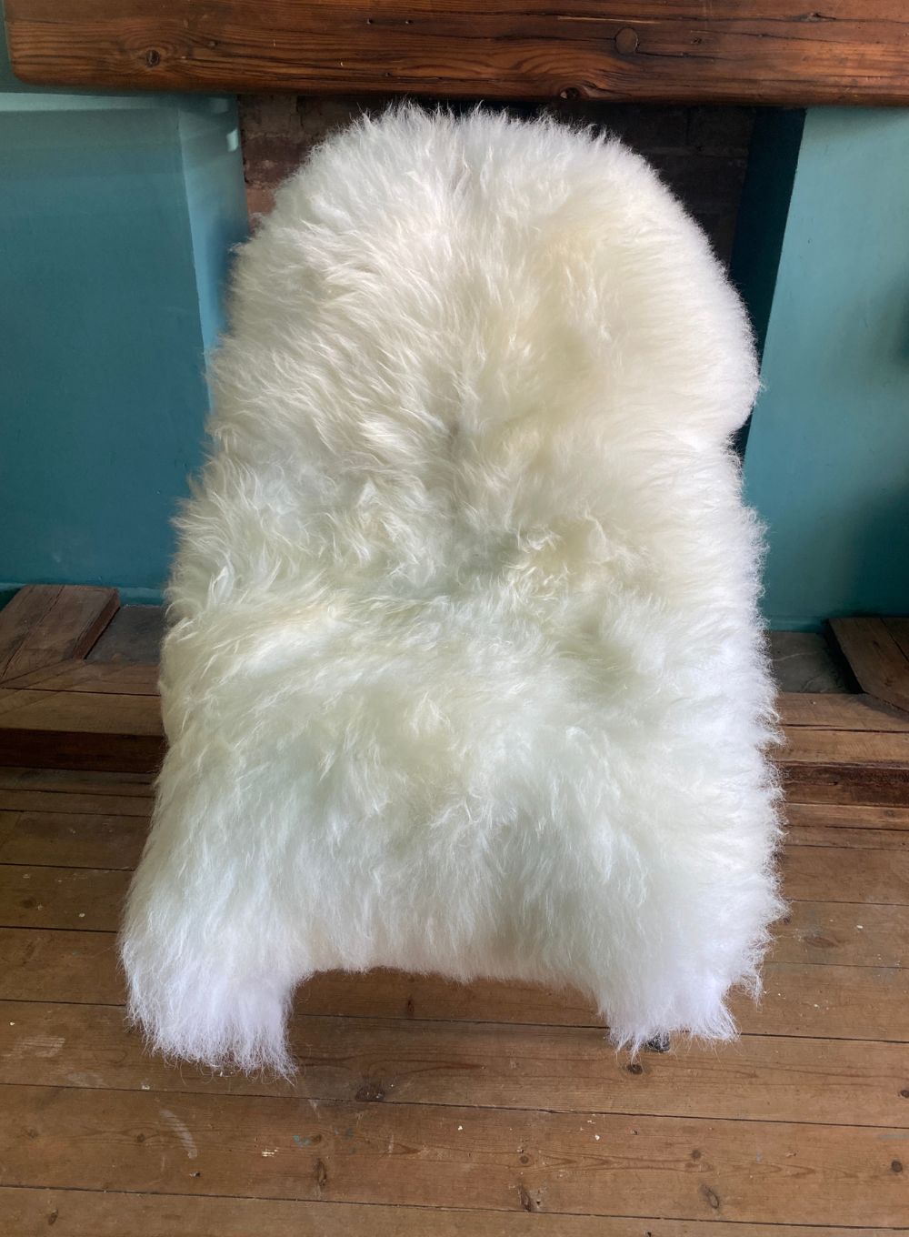 Cream sheepskin rug on chair 